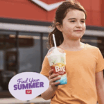 Photo of a young girl holding a Big Cool slushie, with the words "Find Your Summer"
